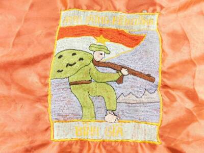 A Vietnam War era Vietcong silk victory flag, stitched with a soldier, "ANH DUNG KIENA WONG BINH GIA LUC LUONG VO TRANG GIAI PHONG MIEN NAM VIET NAM, CHIEN THANG BINH GIA", 1967, 67cm H, 93cm W. - 2