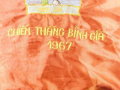 A Vietnam War era Vietcong silk victory flag, stitched with a soldier, "ANH DUNG KIENA WONG BINH GIA LUC LUONG VO TRANG GIAI PHONG MIEN NAM VIET NAM, CHIEN THANG BINH GIA", 1967, 67cm H, 93cm W. - 3