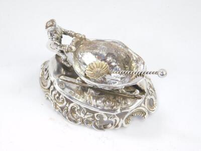 A continental late 19thC silver novelty salt, modelled as a man pushing a troika, embossed with flowers, raised on an oval base pierced and embossed with rococo scrolls and leaves, import marks, William Moering, London 1896, together with a silver salt sp - 2