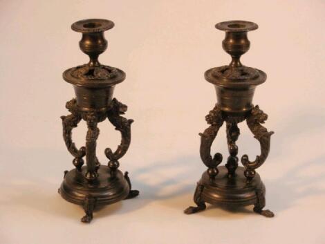 A pair of 19th century bronze candle sticks of classical urn shaped design