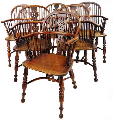 A fine harlequin set of six early 19thC yew wood low back Windsor chairs, with pierced Christmas tree splats, turned legs and crinoline stretchers.