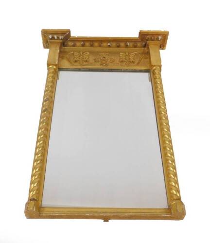 A Regency gilt pier glass, of rectangular form with ball ornamentation to the top and a frieze of gilt gesso foliate scrolls, the glass flanked by two spiral columns, 98cm H, 65cm W. Provenance: The St Georges Collection, Stamford. To be sold WITHOUT RESE