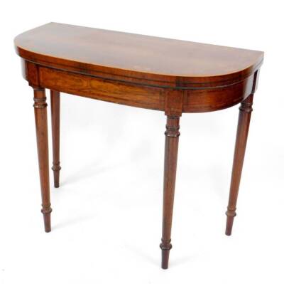 A George III sabicu, yew and rosewood banded card table in the manner of Mayhew & Ince, the bowfront folding top having a deep yew burl banding a fine rosewood crossbanding, detailed inlay frieze raised upon four slender taper turned legs with stringing a