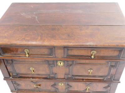 A late 17thC oak and walnut chest of drawers, the top with a moulded edge above four panelled drawers, each with brass tear drop shaped handles on bun feet, 90cm H, 96cm W, 59cm D. - 2