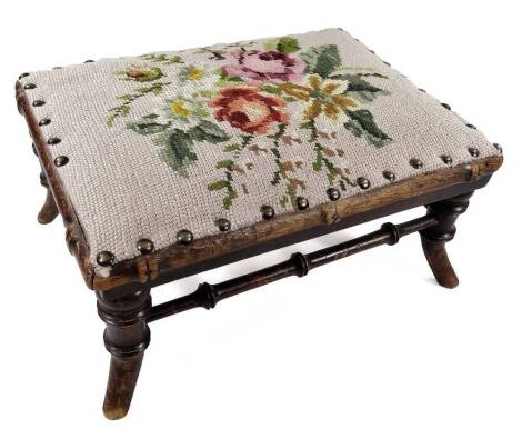 A Victorian mahogany footstool, the later padded top decorated with floral woolwork on simulated bamboo turned supports and tapering legs, 35cm W.