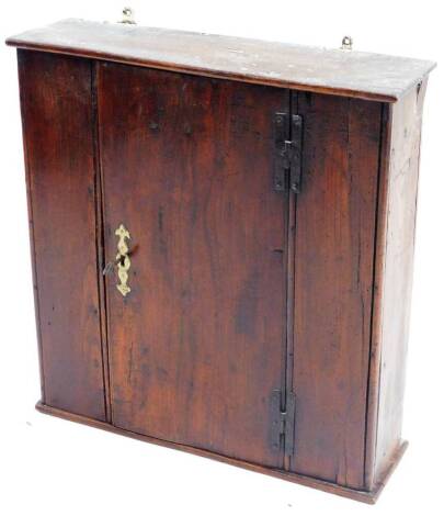 A late 17thC/early 18thC oak wall cupboard, of plain form with a single planked door with iron H hinges, enclosing two shelves, 60cm H, 55cm W.