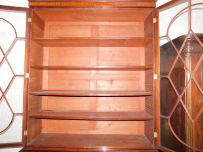 A George III mahogany secretaire bookcase, with a stepped arch pediment with satinwood stringing, flame frieze over two tall hour glass and diamond shaped astragal doors, the fall front secretaire drawer having satinwood and ebony stringing with flamed ca - 5