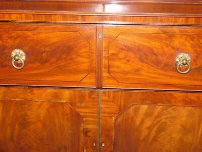 A George III mahogany secretaire bookcase, with a stepped arch pediment with satinwood stringing, flame frieze over two tall hour glass and diamond shaped astragal doors, the fall front secretaire drawer having satinwood and ebony stringing with flamed ca - 7