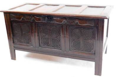 A 17thC oak coffer, the rectangular panel top with a moulded edge, the front carved with two pairs of birds, stylised flowers and interlaced cross-hatch design on stile supports, 67cm H, 127cm W, 56cm D.