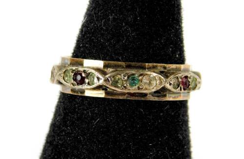 A dress ring, with red and white paste stones, on raised design, yellow metal, marked 9ct & sil, 2.5g all in.