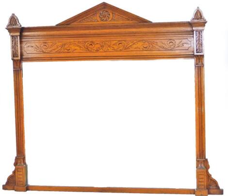 An Edwardian oak overmantel mirror, with fixed pediment and plain glass with upper scroll decoration, flanked by acanthus capped columns, 120cm H, 125cm W, 8cm D.