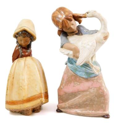 A Lladro porcelain figure modelled as a girl feeding two geese