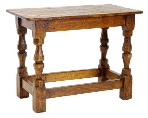 A rectangular oak occasional table by Wilf Squirrelman Hutchinson, on baluster shaped faceted supports, and plain stretchers, carved with squirrel emblem to the stretcher, 40cm H, 54cm W, 30cm D.