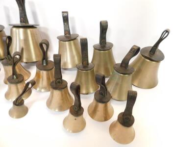 Twenty seven hand bells by J Shaw Son & Company, Leeds Road, Bradford., many with internal hammers, with leather handles indicating the music note. - 2