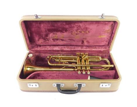 A Melody Maker brass trumpet, cased.