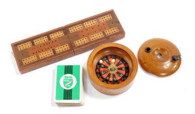 A Victorian sycamore boxed roulette wheel, of circular form, the wheel with a turned bone handle, 11cm Dia, together with a cribbage board box, containing playing cards. (2)