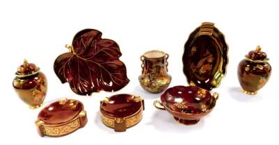 A group of Carlton Ware Rouge Royale pottery, variously decorated, comprising pair of jars and covers, twin handled vase, pair of ashtrays, twin handled sweet meat dish, oval dish, and a leaf shaped dish. (8)