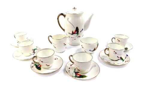 An Art Deco Atlas porcelain part coffee service, decorated with a stylised house and trees, comprising coffee pot, cream jug, sugar bowl, six cups and saucers.