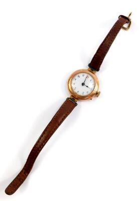 An early 20thC lady's 9ct gold circular cased wristwatch, white enamel dial bearing Arabic numerals, Swiss movement, on a leather strap, 18.2g all in. - 2