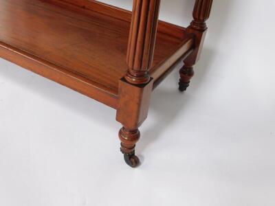 A Victorian mahogany buffet, with three tier shelves, raised on fluted and turned supports, on turned feet, brass capped on castors, 114cm H, 120.5cm W, 48cm D. - 3