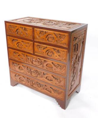 A Chinese hardwood chest of drawers, profusely carved with buildings, trees and figures, with four short over three long drawers, raised on bracket feet, 106.5cm H, 101.5cm W, 50.5cm D. - 2