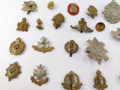 Brass and white metal military cap badges, including South Staffordshire Regiment, Gloucestershire Regiment, Royal Artillery Military Police, and The Argyle and Sutherland Highlanders. (qty) - 3