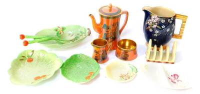 A group of Carlton Ware pottery, including an orange lustre three piece coffee set, chinoiserie decorated, comprising coffee pot, cream jug and sugar bowl, four division toast rack moulded with fox gloves, further leaf pottery and a Carlton Ware Bleu Roy