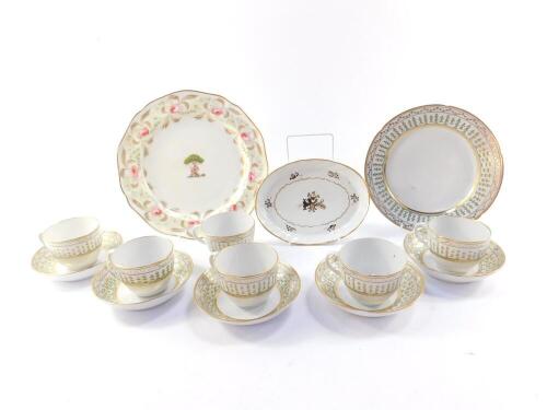 A group of late 18thC porcelain, including tea cups and saucers, an oval teapot stand, and an armorial plate. (qty)