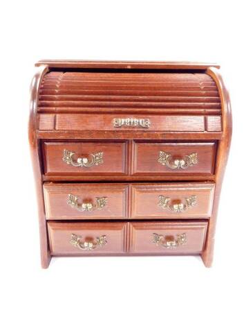 An oak jewellery cabinet, modelled as a tambour fronted chest, with six small drawers, 23cm H, 20.5cm W, 15cm D.