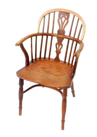 A 19thC yew oak and elm Windsor chair, with vase shaped splat, solid saddle seat, raised on turned legs united by a crinoline stretcher.