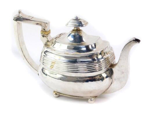 A George III silver teapot, of fluted ogee form, raised on four ball feet, makers mark indistinct, London 1808, 11.52oz.