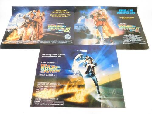 Three Back To The Future Quad posters, by Stephen Spielberg, comprising Back To The Future, He's The Only Kid Ever To Get Into Trouble Before He Was Born., Back To The Future II, Getting Back Was The Only Way., and Back To The Future III, They've Saved Th