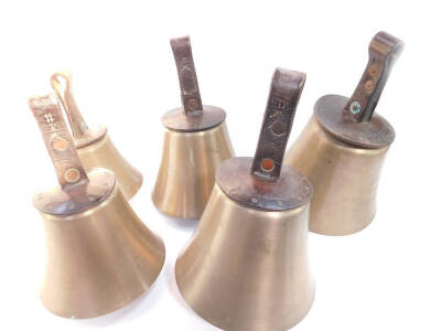 Five hand bells, notes C D E F# and G with tooled leather handles stamped G W.