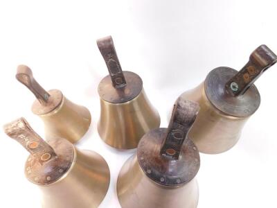 Five hand bells, notes C D E F# and G with tooled leather handles stamped G W. - 2