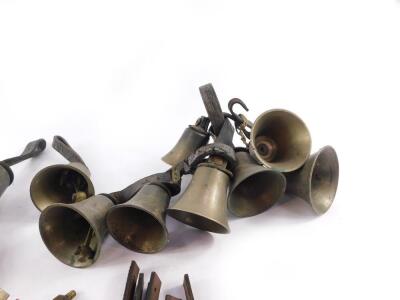 Hand bells, some with hammers and tooled leather handles, together with spare handles and hammers. (qty) - 4