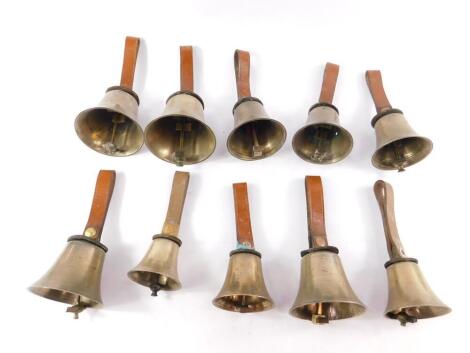 A part set of hand bells, with hammers and leather mounts, later handles, with a card stating 'Part of a set of hand bells used by the village tune-ringers c1850, originally owned by The Royal Uttoxeter Prize All England Hand Bell Ringers'.