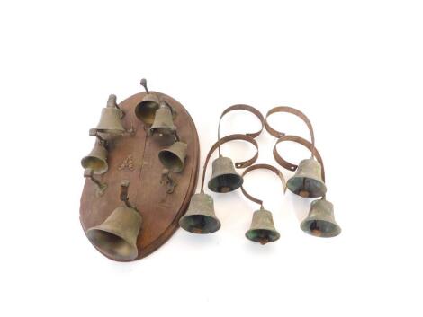 A set of five wall mounted servant's bells, together with an oval wall mounted part set of bells. (qty)