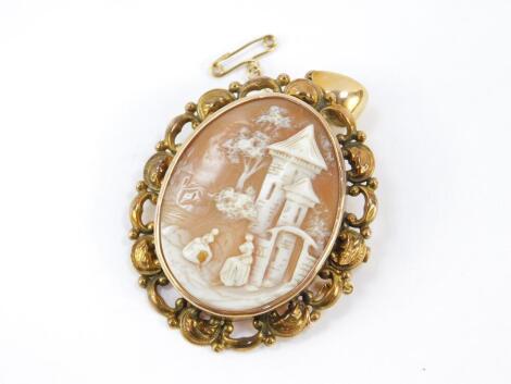 A late 19thC European cameo brooch, carved with figures in a landscape with castle, set in yellow metal with safety chain as fitted, 12.1g all in.