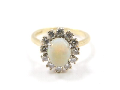 An 18ct gold opal and diamond ring, the opal set in a surround of twelve brilliant cut diamonds, approx 0.75cts, size P, 5.0g all in. - 2