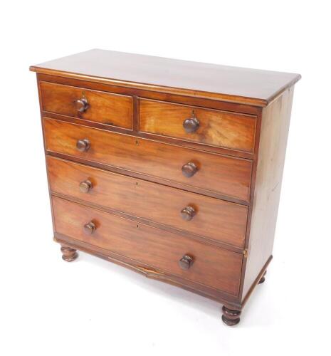 A Victorian mahogany chest of drawers, with two short over three long graduated drawers, raised on turned feet, 101cm H, 104cm W, 46.5cm D.