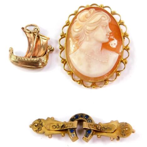 A 9ct gold and shell cameo, bust portrait of a lady, Victorian 9ct gold and sapphire set horseshoe bar brooch, and a 9ct gold charm modelled as a Viking longship, 8.6g all in.