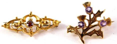 A 9ct gold and amethyst brooch formed as thistles, together with a Victorian 9ct gold and garnet set brooch, 5.1g. (2)