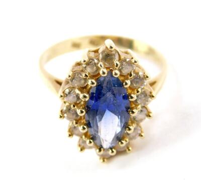An Alexandrite set ring, the marquise blue centre stone in a surround of brilliant white stones, stamped 585, size N, 4.7g.