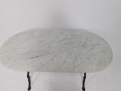 An oval white marble and cast iron table, raised on a shaped supports united by an X frame stretcher, 72cm H, 119cm W, 60cm D. - 2