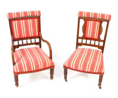 A Victorian walnut nursing carver chair, with red and white striped fabric back and overstuff seat, raised on turned legs, capped on castors, together with a matching single nursing chair. (2)