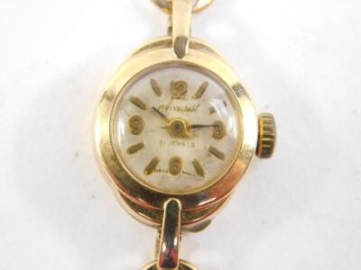 An Accurist ladies 9ct gold cased wristwatch, the circular silver dial bearing arabic numerals as quarters, on a gold bracelet with safety chain as fitted, 10.7g, together with a mid 20thC 9ct gold cased ladies wristwatch, the circular dial bearing arabic - 2