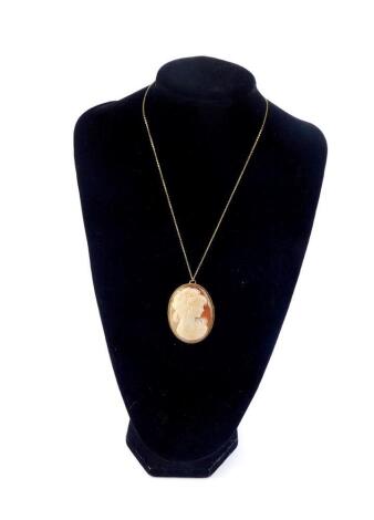 A 9ct gold and shell cameo brooch, bust portrait of a lady, with pendant mount, on a 9ct gold chain.