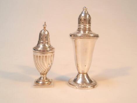 A silver pepper pot and a sterling example