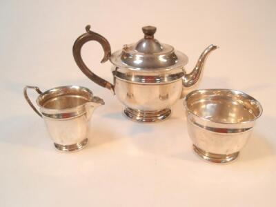 A George VI silver three piece tea set of circular form