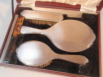 A modern cased silver backed dressing table set